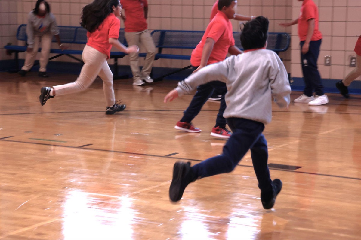M.S. 319 students running and playing during Open Gym in the school gymnasium